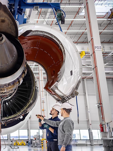 Engineers inspecting airplane engine